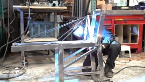One Hat One Hand fabricating the crane