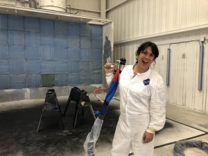 A woman holding a spray gun