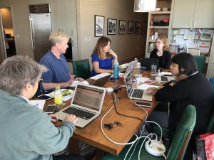 a group of people working around a table